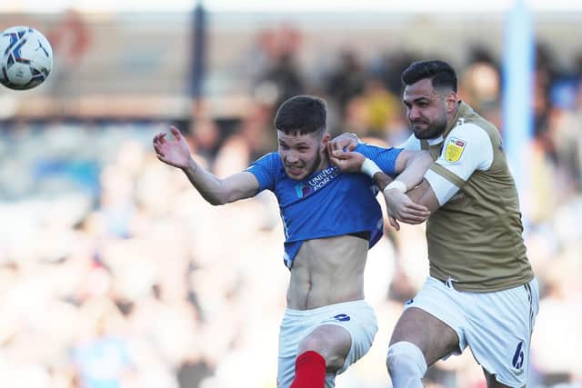 George Hirst is held up by Wycombe defender Ryan Tafazolli during today's game