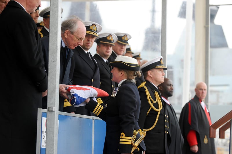 Commanding officer commander Claire Thompson OBE hands the ensign to Malcolm Rifkind (170423-6585)
