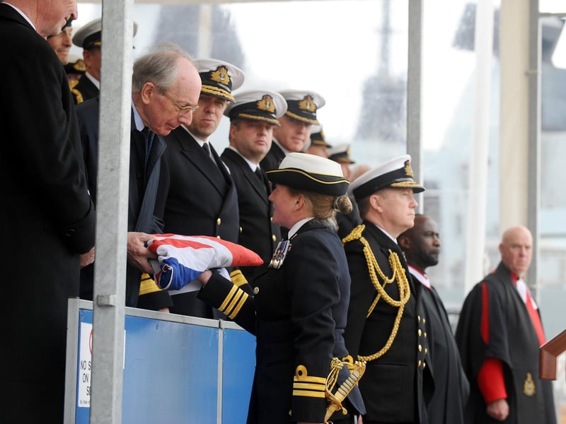 Commanding officer commander Claire Thompson OBE hands the ensign to Malcolm Rifkind (170423-6585)