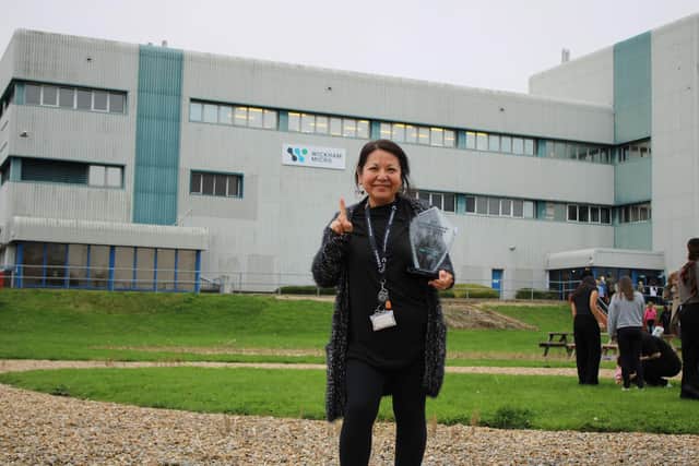 Outside Cormica’s Wickham Micro site in Gosport, a team member holds the physical award for the UK’s Top Microbiological Testing Service 2025.