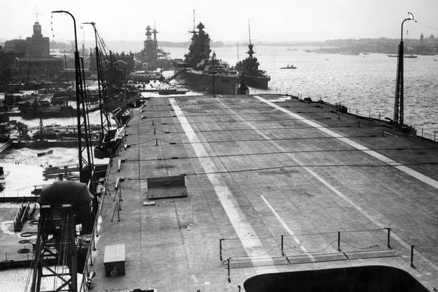 The Royal Navy Nelson-class battleship HMS Rodney and the Revenge-class battleship HMS Royal Oak can bee seen tied up at anchor as viewed from the flat top flight deck of the fleet aircraft carrier HMS Ark Royal in Portsmouth Dockyard on 23 November 1938 in Portsmouth, United Kingdom.  (Photo by Reg Speller/Fox Photos/Hulton Archive/Getty Images).