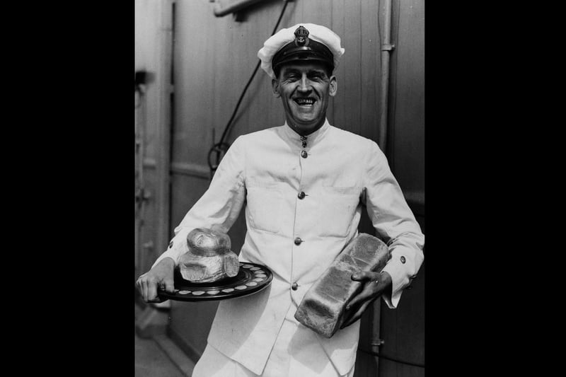 16th April 1939: Chief petty officer cook Raw King holding a silver loaf award, aboard the new aircraft carrier 'Ark Royal'. He has won the Challenge Silver Loaf making him the fleet's champion baker. (Photo by Fox Photos/Getty Images)