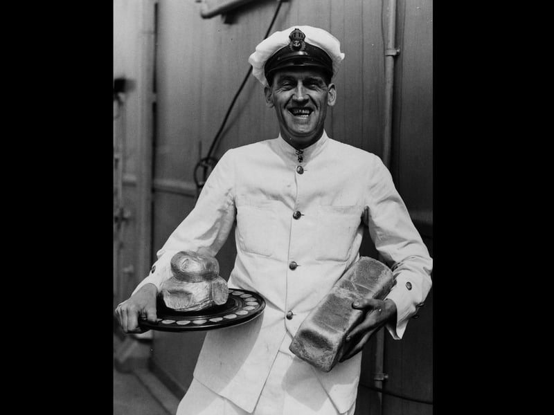 16th April 1939:  Chief petty officer cook Raw King holding a silver loaf award, aboard the new aircraft carrier 'Ark Royal'. He has won the Challenge Silver Loaf making him the fleet's champion baker.  (Photo by Fox Photos/Getty Images)