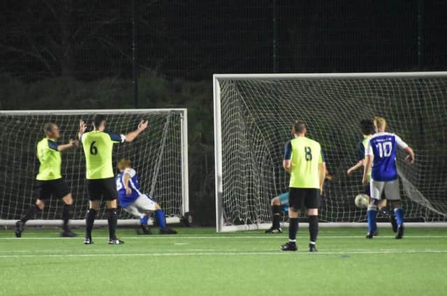 Steve Field (middle, blue) scores Denmead's second goal in their 4-=0 L4 Teamwear Cup win against Harvest at Front Lawn. Picture: Paul Proctor.