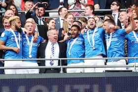 Kenny Jackett, centre left, celebrates Pompey's Checkatrade Trophy triumph with his players at Wembley. Picture: Joe Pepler