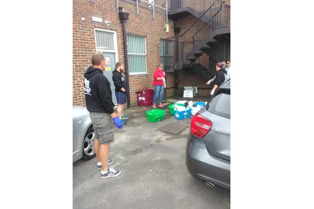 Heart of Hayling Boxing Academy volunteers working to sort prescriptions outside Hobbs Pharmacy without the gazebo, which was stolen and then returned 