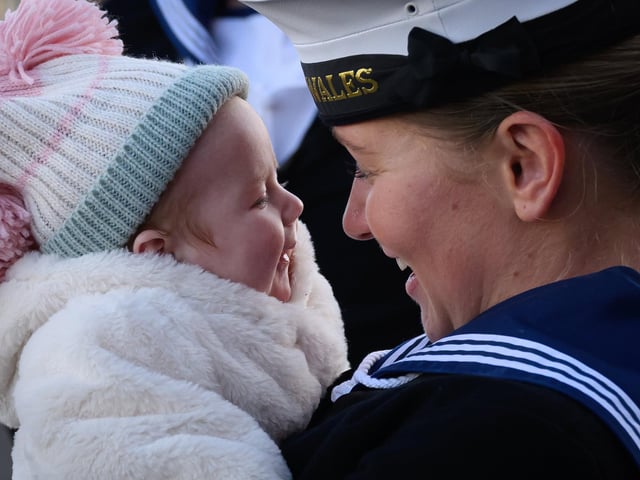 Able Seaman Lucy Phillips is greeted by new family member Heidi, aged nine weeks, following the arrival of the United Kingdom's biggest warship, the HMS Prince of Wales aircraft carrier, following a three months deployment, on December 11, 2023. Picture: Leon Neal/Getty Images.