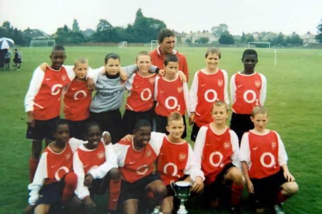 Christian Burgess (back row, second in from right) celebrates another trophy with Arsenal
