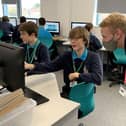 Christian Barrett, Systems Engineer Placement Student, Lockheed Martin, helping a student from UTC Portsmouth complete the cyber themed challenge