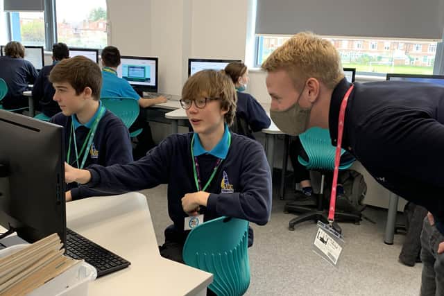 Christian Barrett, Systems Engineer Placement Student, Lockheed Martin, helping a student from UTC Portsmouth complete the cyber themed challenge