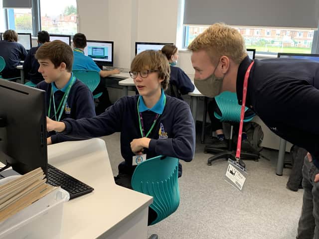 Christian Barrett, Systems Engineer Placement Student, Lockheed Martin, helping a student from UTC Portsmouth complete the cyber themed challenge