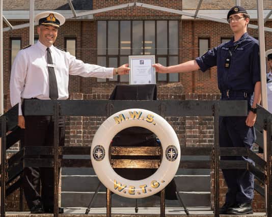 Engineering Technician (ET) Jordan Dalgleish, right,  received the Herbert Lott Award from officer commanding weapon engineering training group Commander Jonathan Pearce in a socially-distanced ceremony at HMS Collingwood..