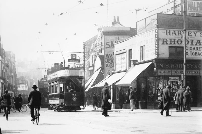 A wonderful photograph of pre-war Commercial Road, Portsmouth, at its junction with Charlotte Street. A policeman directs traffic.