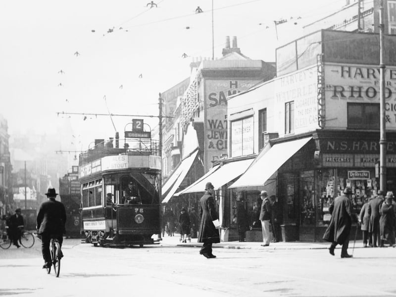 A wonderful photograph of pre-war Commercial Road, Portsmouth, at its junction with Charlotte Street. A policeman directs traffic.