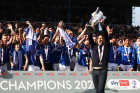 Pompey boss John Mousinho lifts the League One trophy. Photo by Peter Nicholls/Getty Images.