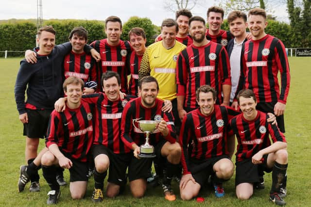 Dave Bridger holds the Len Den Cup as Carberry celebrate their 2-0 win over Horndean United in 2016/17. Picture: Kevin Shipp