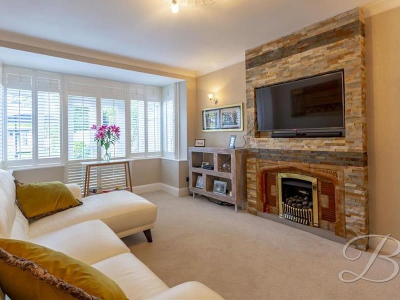 One of the most appealing parts of the house is this sitting room. With a carpeted floor, a fitted gas fireplace and bay window to the front, it provides all the necessary home comforts and also offers wooden plantation shutters that cool the room in summer and hold the heat in during winter..