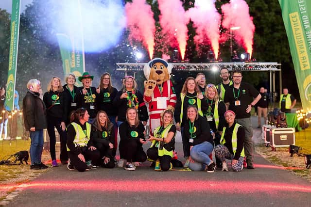 Members of the HIOWAA team with the award at the charity's 5k fun run, Dash in the Dark.