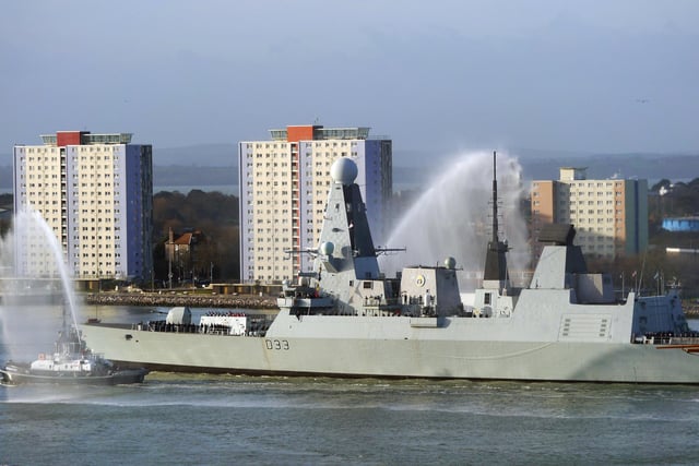 HMS Dauntless with water cannon tug escorts passing the Gosport tower blocks as she deployed to the Gulf from her home base in Portsmouth on 2 January 2015.
Picture: Courtesy of Stephen Ashton
