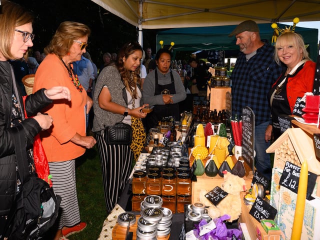 Pictured is: Visitors to the Honey Bee Happy Stall at the South Downs Food Festival Picture: Keith Woodland (140921-6)