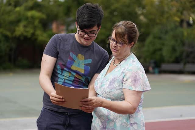 Lorcan Bonser-Wilton looks at his GCSE results with his mother Helen Bonsen-Wilton (right) at Portsmouth Grammar School. Pic: Andrew Matthews/PA Wire