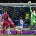 Pompey keeper Alex Bass makes a save to deny Rochdale a goal. Picture: Robin Jones