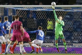 Pompey keeper Alex Bass makes a save to deny Rochdale a goal. Picture: Robin Jones