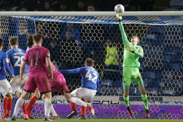 Pompey keeper Alex Bass makes a save to deny Rochdale a goal. Picture: Robin Jones