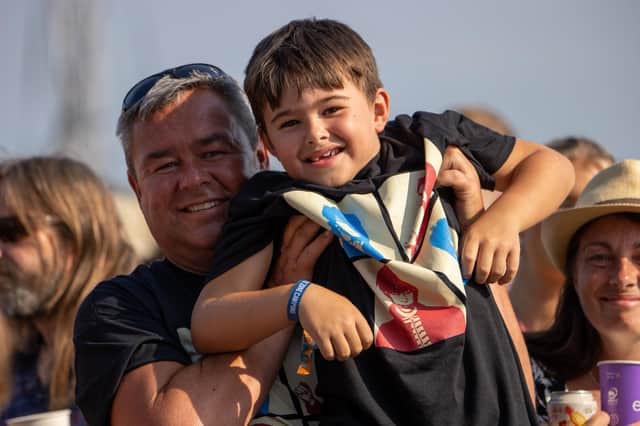 Pictured - Young festival fan Henry Baron and his Dad enjoying Inhaler. Photos by Alex Shute.