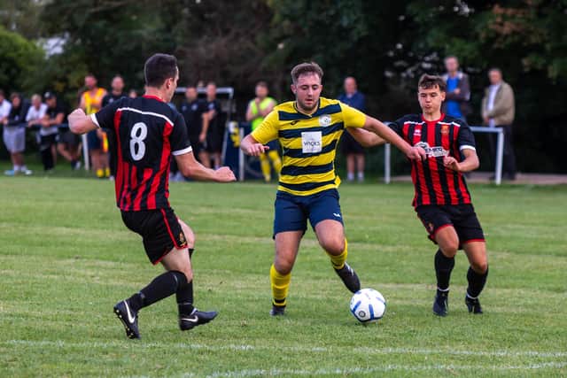 Paulsgrove's Luis Tyler with two Fleetlands players. Picture: Mike Cooter