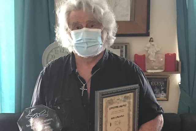 Bob Caruana with his certificate and glass award