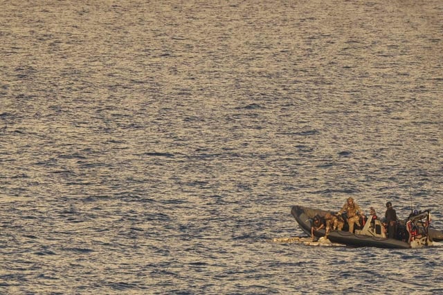 HMS Dauntless' sea boat recovers packages jettisoned by a suspect vessel in the Caribbean Sea.