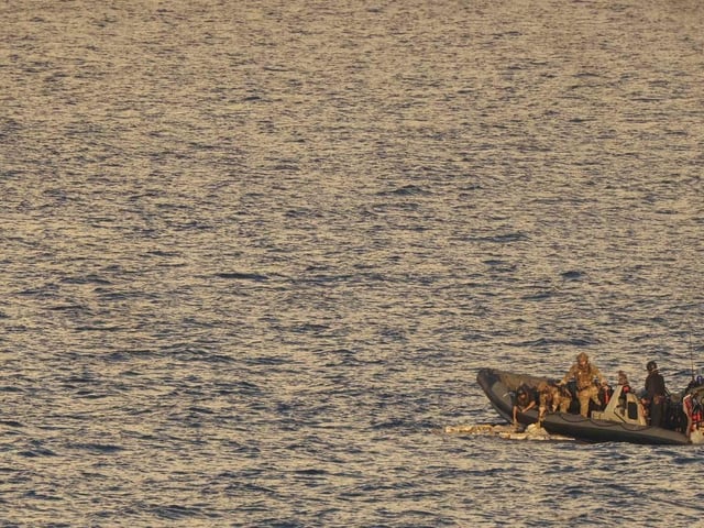 HMS Dauntless' sea boat recovers packages jettisoned by a suspect vessel in the Caribbean Sea.