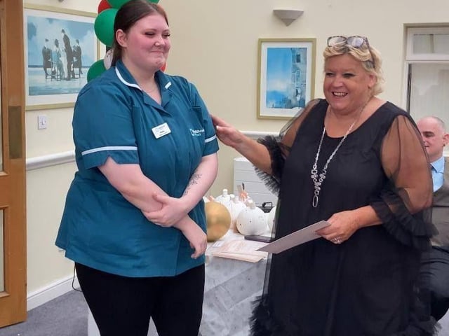 Receiving their resident-nominated award for exceptional support and dedication.