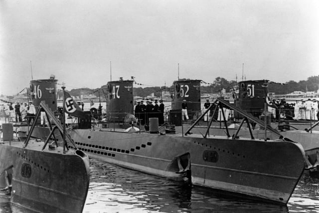 Kapitanleutnant Gunther Prien and his officers gather on the deck of the U-47, a Type VIIB U-boat submarine of the German navy (Kriegsmarine) while tied up alongside the U-46, U-52 and U-51 Unterseeboot at the Germaniawerft naval base on 1 August  1939 in Kiel, Germany. Gunther Prien and U-47 sank the British battleship HMS Royal Oak at anchor in the Home Fleet's anchorage in Scapa Flow on 14 October 1939. (Photo by Central Press/Hulton Archive/Getty Images)