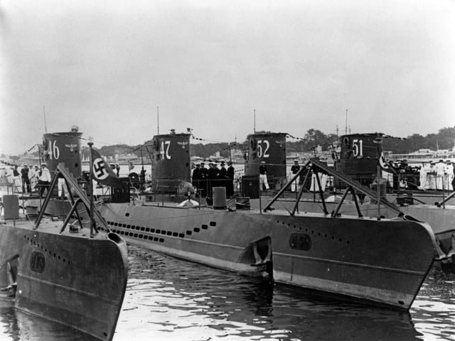 Kapitanleutnant Gunther Prien and his officers gather on the deck of the U-47, a Type VIIB U-boat submarine of the German navy (Kriegsmarine) while tied up alongside the U-46, U-52 and U-51 Unterseeboot at the Germaniawerft naval base on 1 August 1939 in Kiel, Germany. Gunther Prien and U-47 sank the British battleship HMS Royal Oak at anchor in the Home Fleet's anchorage in Scapa Flow on 14 October 1939. (Photo by Central Press/Hulton Archive/Getty Images)