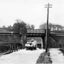 THEN: Dean Lane End, on the road from Rowlands Castle to Finchdean. The road is flooded by the Lavants that rise every seven years without fail. Picture: Barry Cox  postcard collection.
