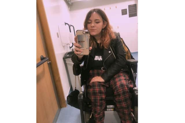 Faith Martin, music fan and disability campaigner from Portsmouth, takes a selfie in a changing place toilet