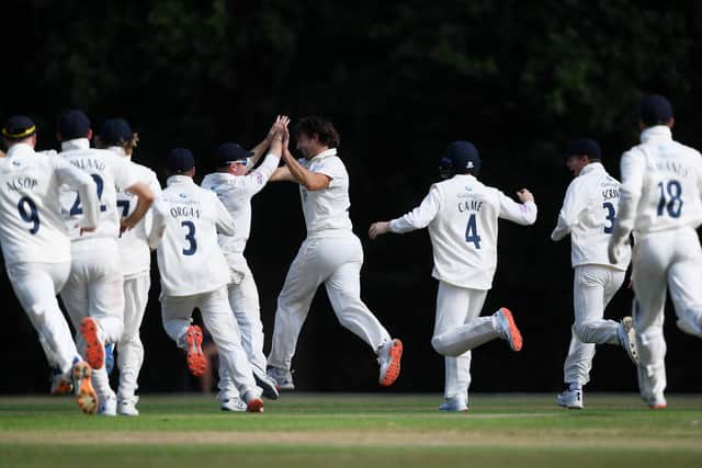 James Fuller celebrates his hat-trick as his jubilant team-mates prepare to mob him. Photo by Alex Davidson/Getty Images.