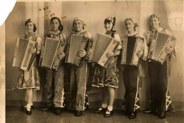 Maisie Bartlett playing the accordion.