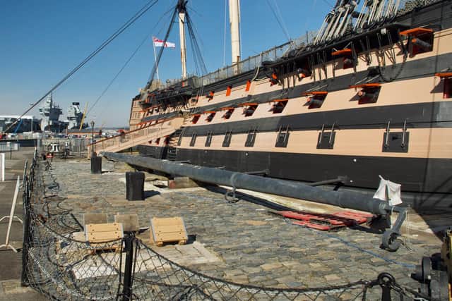 HMS Victory pictured at the dockyard with aircraft carrier HMS Prince of Wales in the background. Photo: Julian Civiero