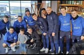 Two year old Rio Carraher met Portsmouth FC players in Starbucks. 

Pictured: From L to R: Zak Swanson, Owen Dale, Colby Bishop, Ryan Tunnicliffe, Simon Bassey (interim manager next to child), Sean Raggett, Reeco Hackett, Connor Ogilvie, Denver Hume and Joe Morrell stood with Rio Carraher in the middle.