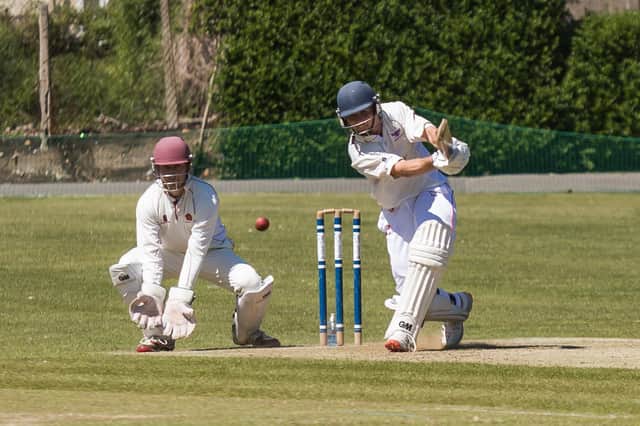 Havant wicket-keeper Simon Loat watches on as Weybridge add more runs at Havant Park. Picture: Mike Cooter