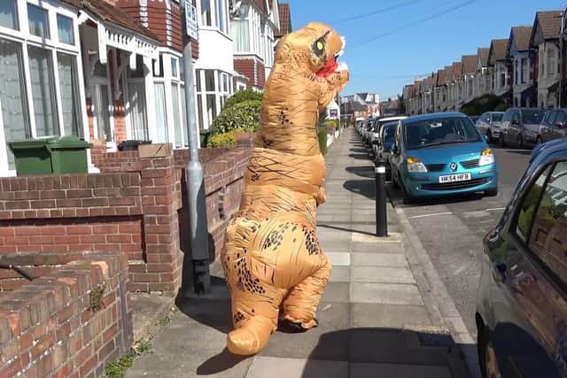 Hannah Pilcher, 29, of North End dresses up as a dinosaur to entertain children in Portsmouth during lockdown.