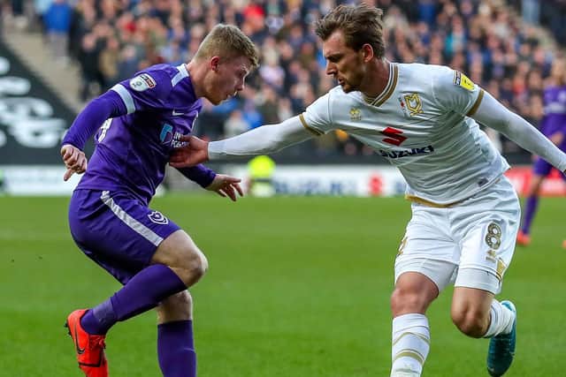 Alex Gilbey battles Andy Cannon for the ball during Pompey's trip to MK Dons in December. Picture: Nigel Keene