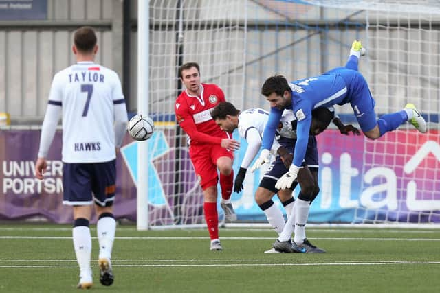 Keeper Ross Worner goes over the top of defender Moussa Diarra during the home win over Hungerford. Picture: Chris Moorhouse