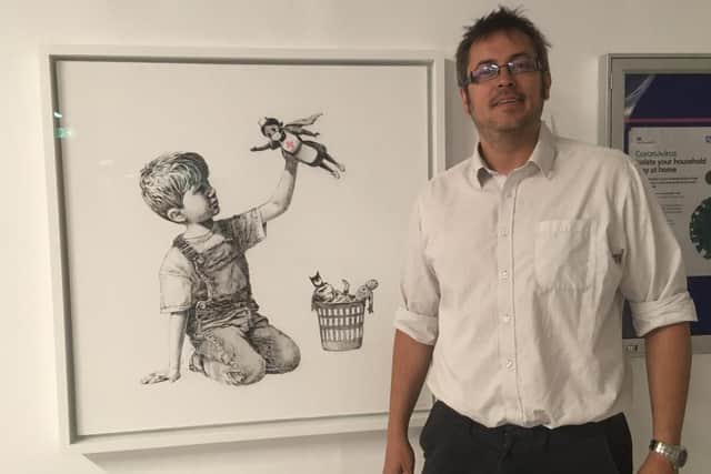 Recording radiographer Humphrey Hardless, from Southsea, next to the Banksy at Southampton General Hospital. Picture: Southampton General Hospital/PA Wire