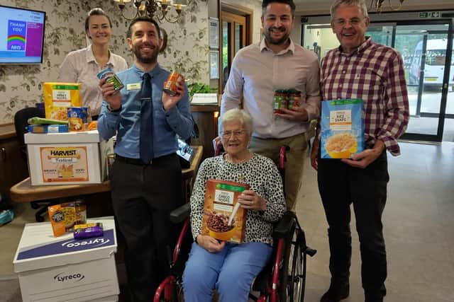 Team members and residents at Ancasta Grove presented their donations to the food bank.