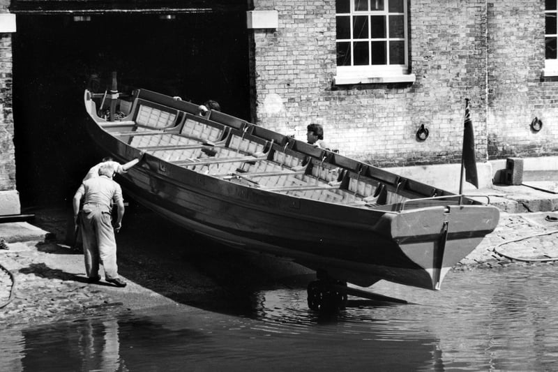 A restored cutter takes to the water after its restoration in the mast pond, Portsmouth Dockyard, 1994. The News PP5644