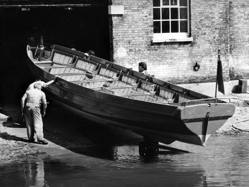 A restored cutter takes to the water after its restoration in the mast pond, Portsmouth Dockyard, 1994. The News PP5644